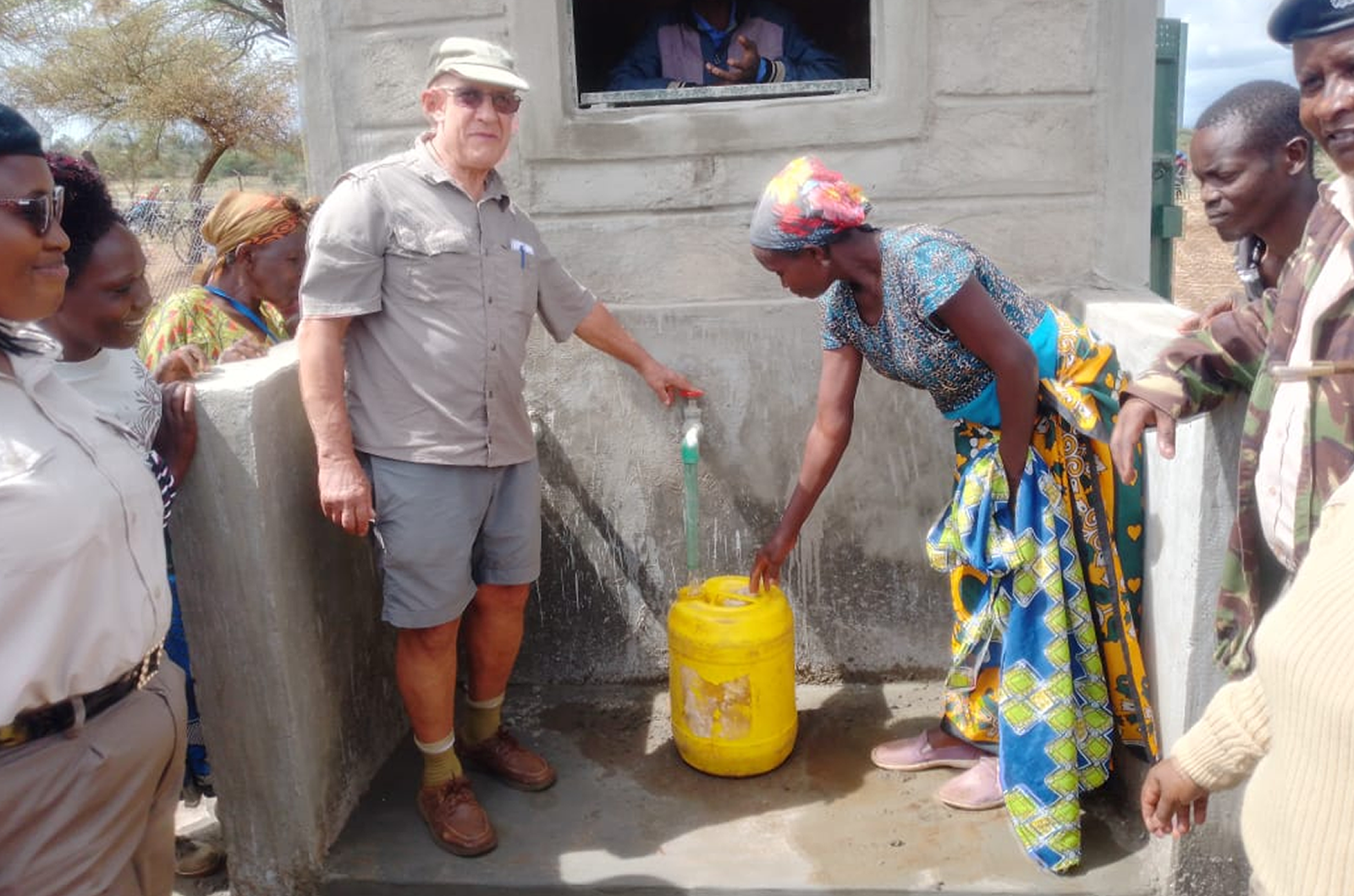 Donor with residents of Mbonzuki during launching of the mechanized borehole.